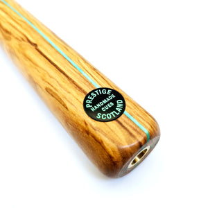 Close-up of Prestige Cues Green Plate snooker cue butt showing handmade label and mint veneer detailing, crafted in Scotland.