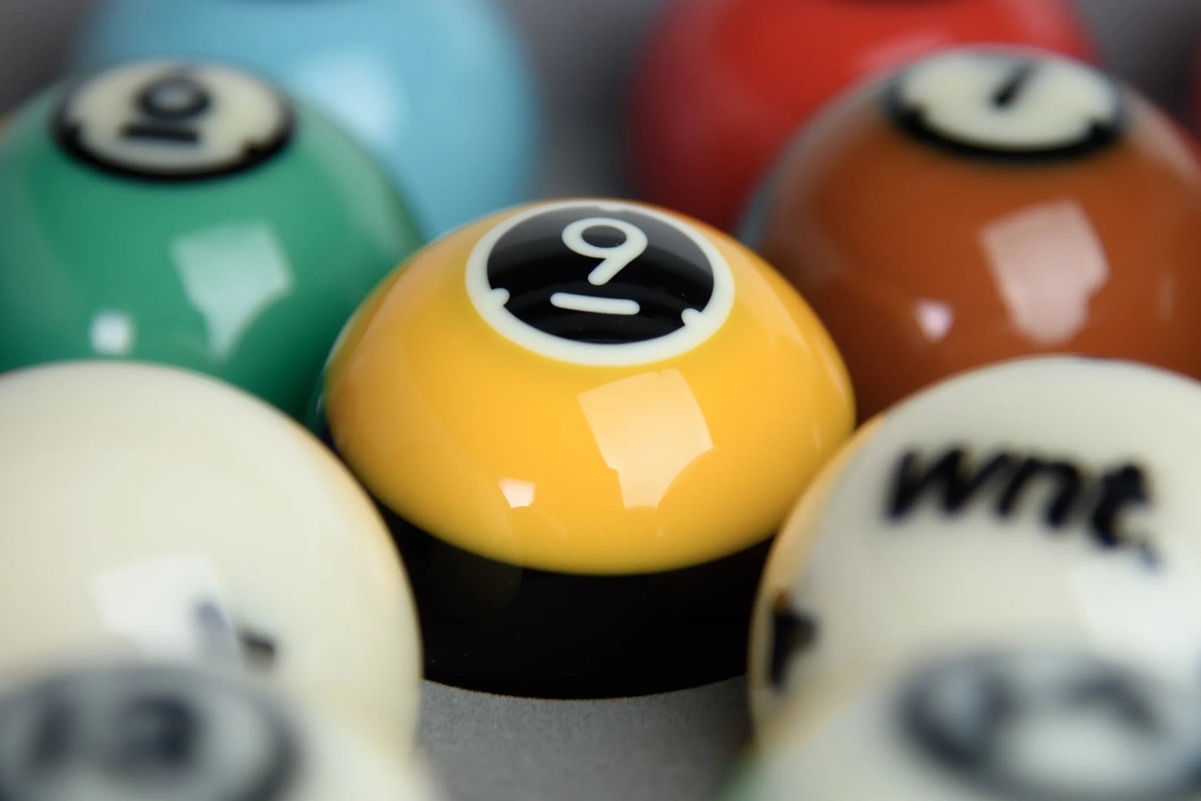 Close-up of Dynaspheres Titan pool balls with a focus on the number 9 ball.