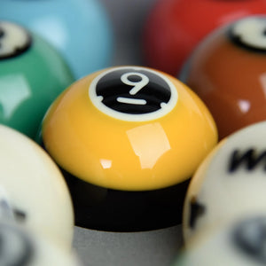Close-up of Dynaspheres Titan pool balls with a focus on the number 9 ball.