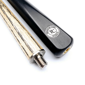 Close-up of Premium Cues Evolve 57" titanium joint showing ash shaft and ebony butt with PC logo, crafted for precision billiards.