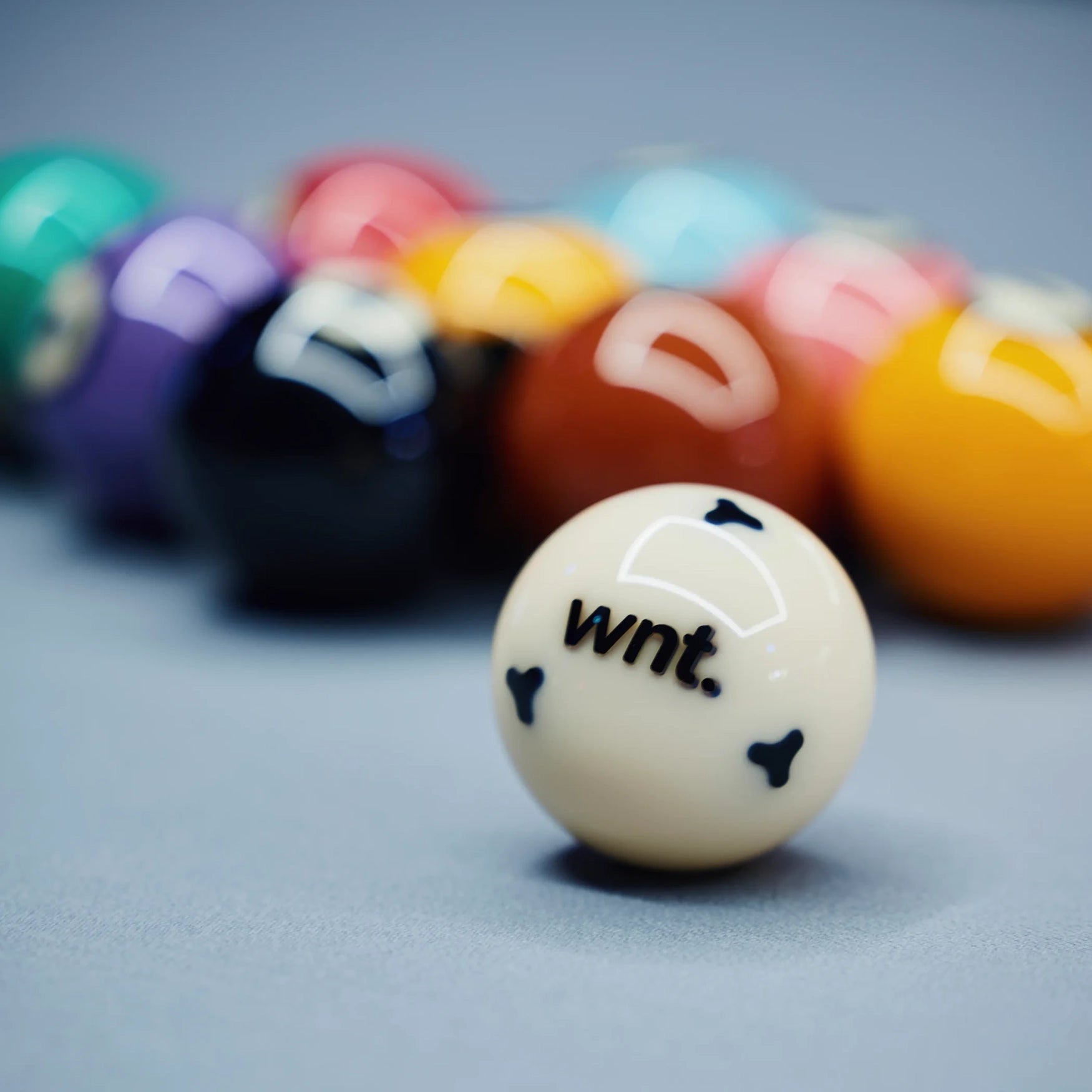 Colorful pool balls with 'WNT.' text on a gray background