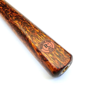 Close-up of Premium Cues ICON No.020 pool cue butt featuring rich lava rosewood grain and engraved logo for high-end billiards performance.