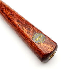 Close-up of Asia Cues Signature No.560 cue butt featuring gold-etched logo on burl wood, highlighting its handmade quality and elegant design.
