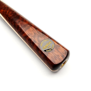 Close-up of Asia Cues Signature No.559 cue butt showcasing the polished snakewood finish and engraved signature badge for authenticity.