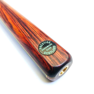 Close-up of Prestige Cues Green Plate 3 snooker cue butt with Cocobolo wood, yellow veneer, and 'Handmade in Scotland' badge.