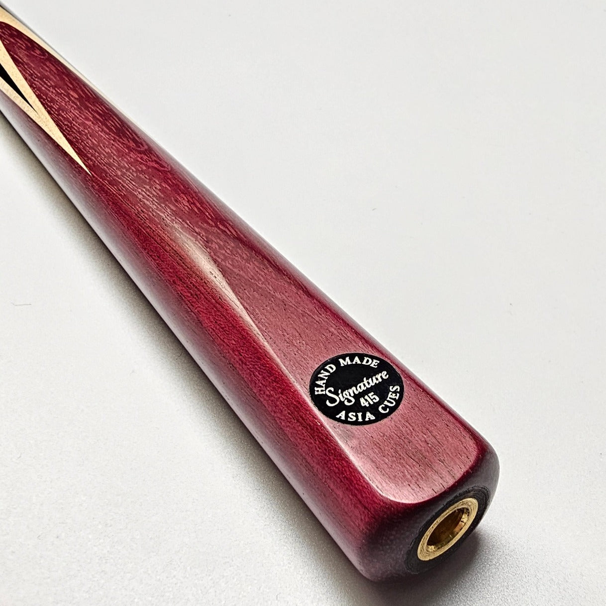 Asia Cues Signature One Piece Snooker Cue  Handmade Ebony Butt with 4 lower splices of Purple Heart and 4 veneers of Thick Birdseye Maple. Badge View