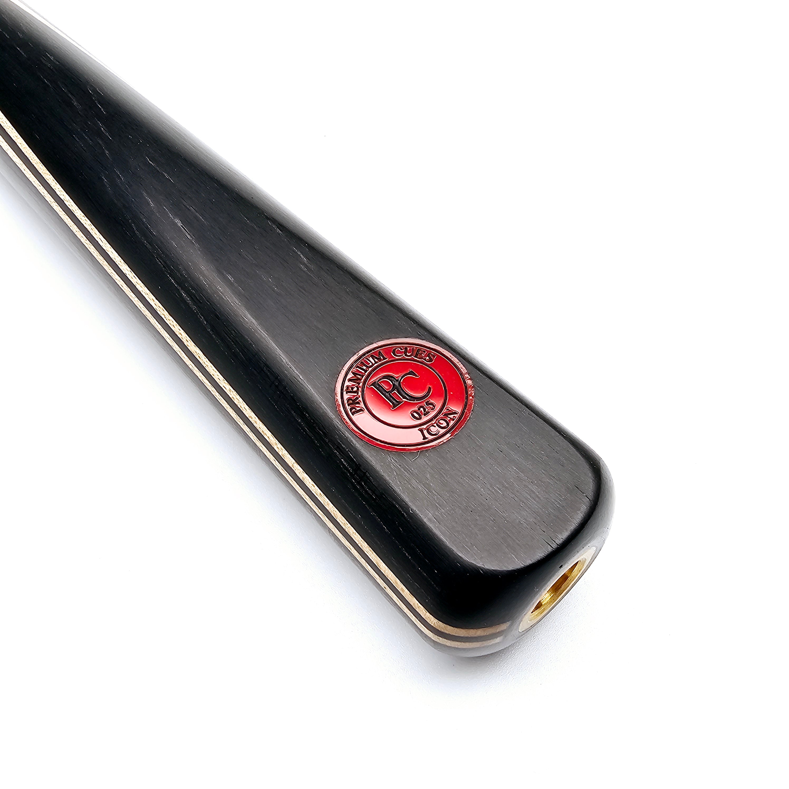 Close-up of Premium Cues ICON No.025 snooker cue butt with red logo badge, highlighting fine craftsmanship and titanium ferrule fitting.