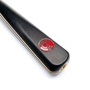 Close-up of Premium Cues ICON No.025 snooker cue butt with red logo badge, highlighting fine craftsmanship and titanium ferrule fitting.