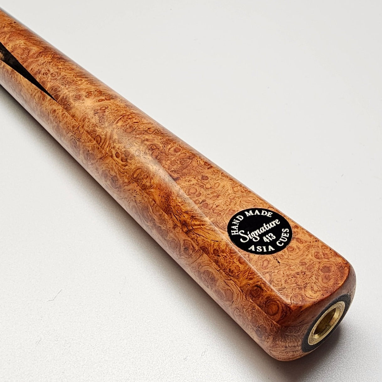 Asia Cues Signature No.413 - One Piece Pool Cue  Handmade Ebony Butt with 4 lower splices of Amboyna Burl. Badge View