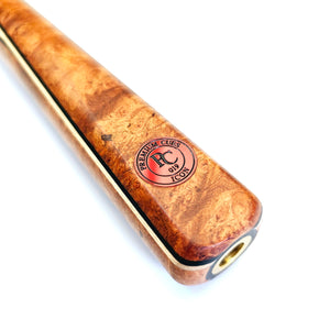 Close-up of Premium Cues ICON No.019 butt with Amboyna Burl wood, gold ring detailing, and Premium Cues logo for authentic craftsmanship.